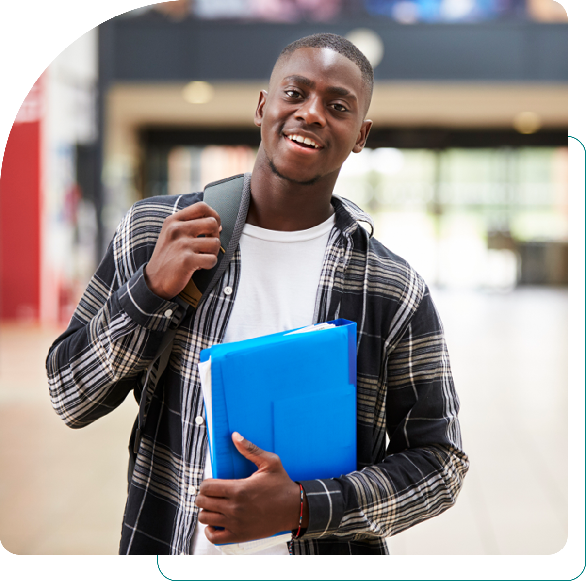 Student holding folders in a school hallway.