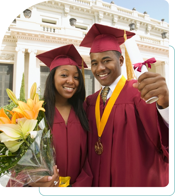Two graduates in maroon gowns celebrating with flowers and medals.