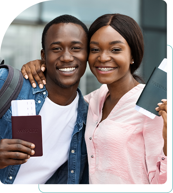 Happy couple holding passports and boarding passes at the airport.